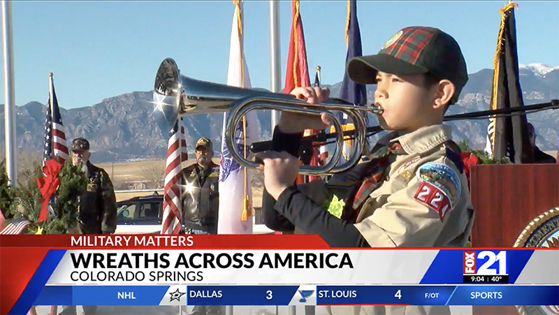 boy playing trumpet at memorial event to honor war heroes in Colorado Springs